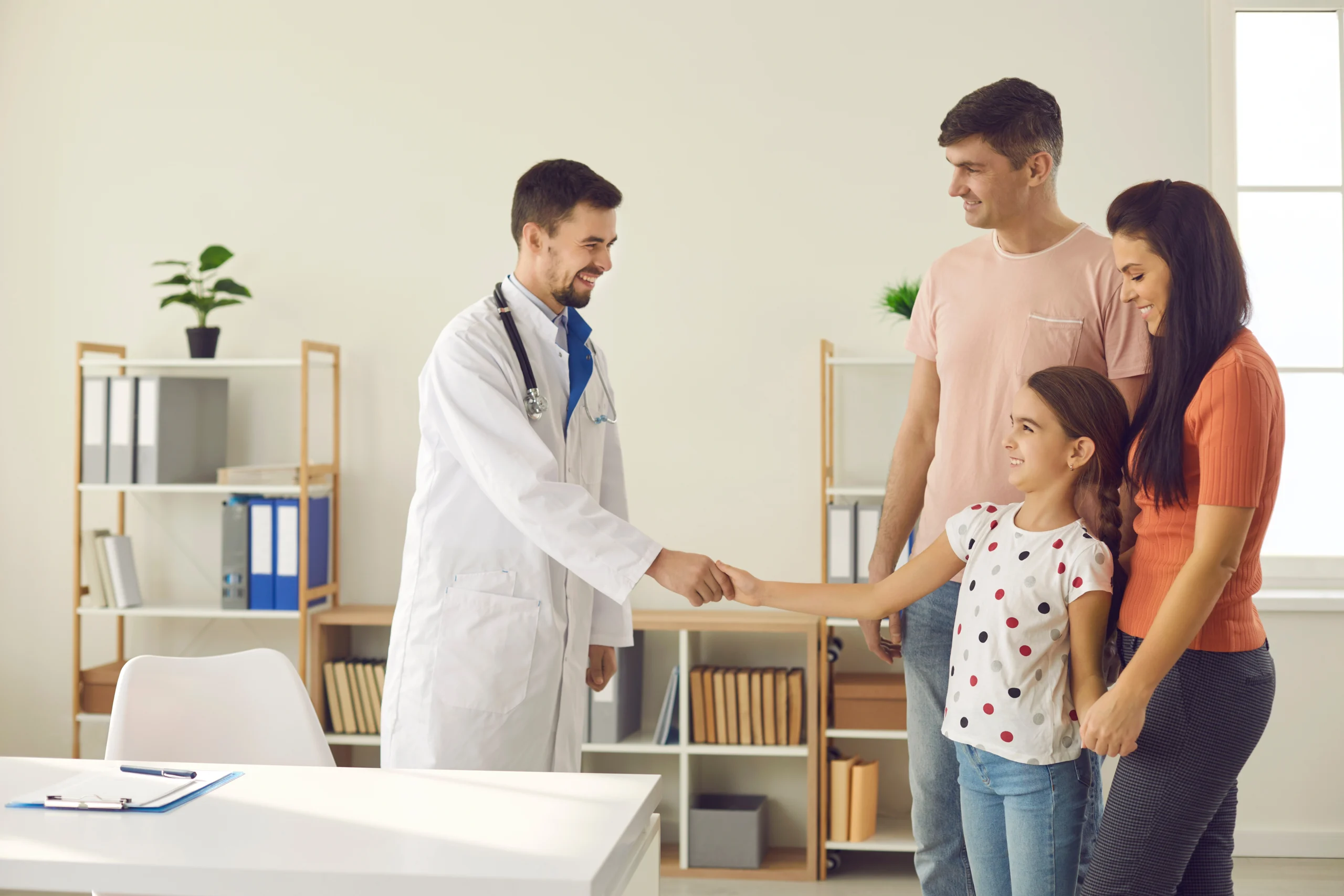 Family practice doctor with a parent and child during a visit